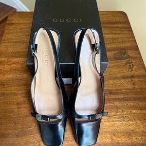 Black Gucci low-heeled sling back pumps